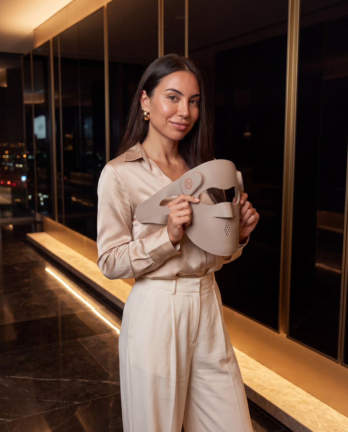 Johanna holding the P.s. I Love You beauty mask — crest on the button pod, signature on the cheek