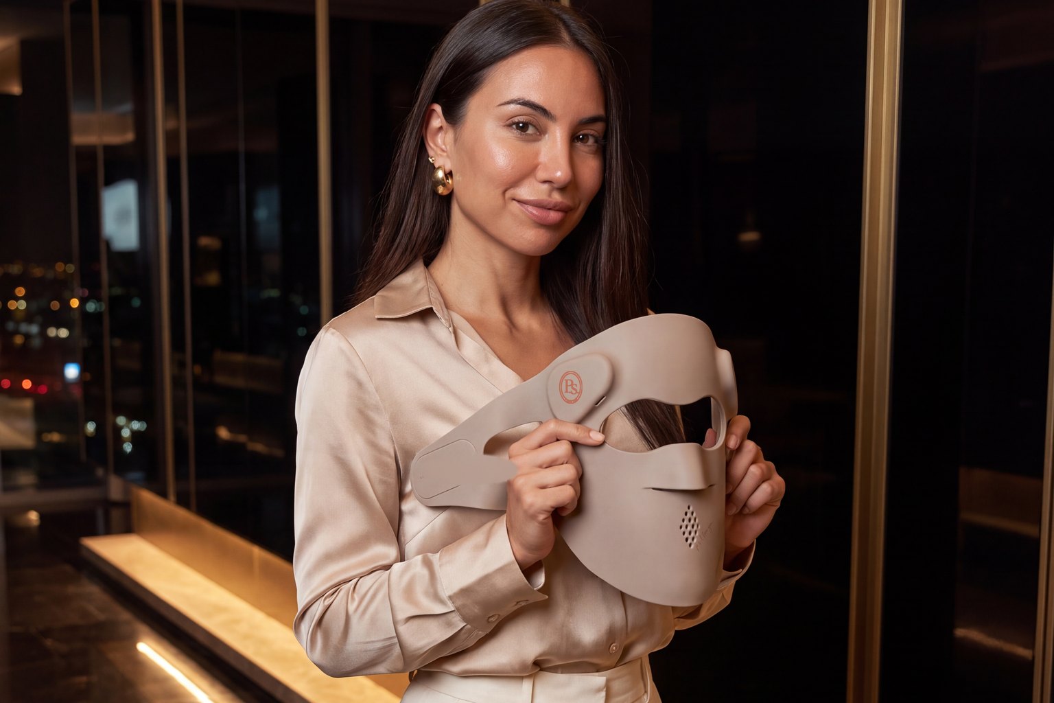 Johanna in a champagne satin blouse holding the P.s. I Love You in a Dubai hotel lobby at night